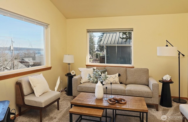 living room with lofted ceiling, carpet floors, plenty of natural light, and baseboards