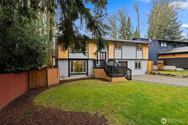 view of front of property with a front yard and fence