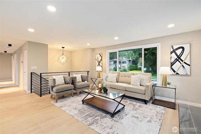 living area with recessed lighting, baseboards, and light wood-style floors