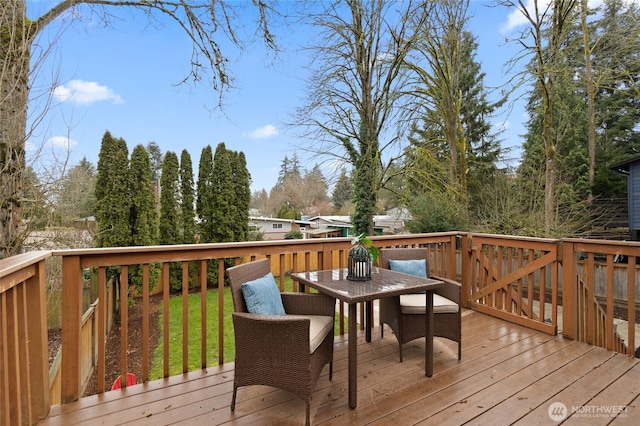 wooden deck featuring outdoor dining area