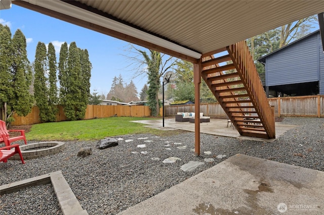 view of yard featuring a patio area, an outdoor living space with a fire pit, stairs, and a fenced backyard