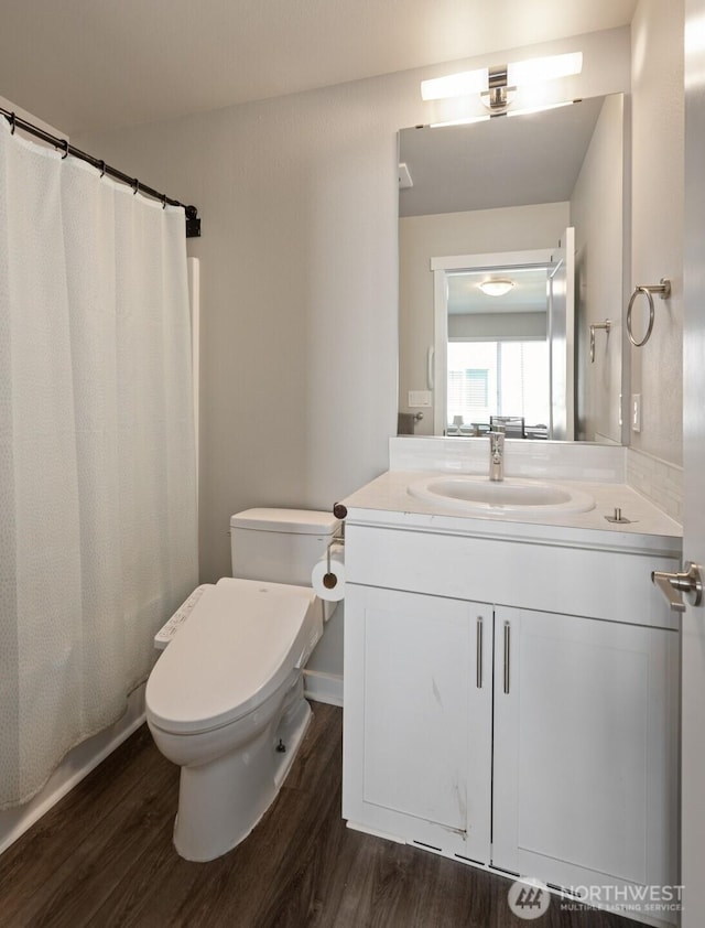 bathroom with a shower with curtain, vanity, toilet, and wood finished floors