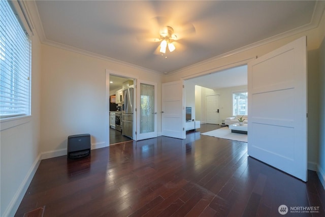 spare room with baseboards, visible vents, ornamental molding, and dark wood-type flooring