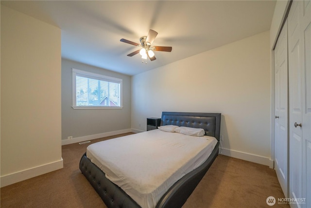 bedroom featuring a ceiling fan, baseboards, a closet, and carpet flooring