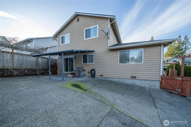 back of property featuring crawl space, a patio area, and a fenced backyard