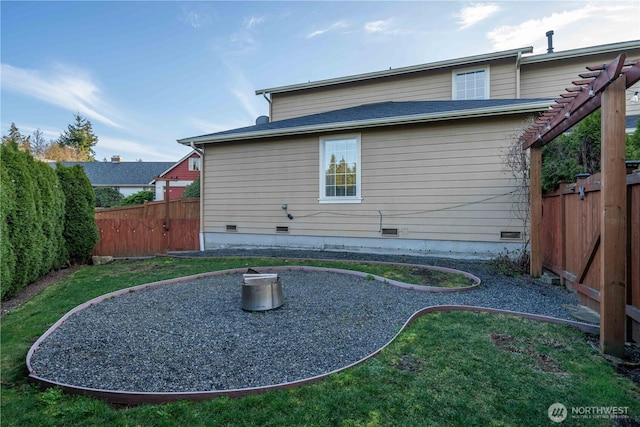 back of house featuring crawl space and fence