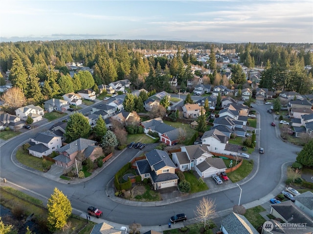 bird's eye view featuring a residential view and a wooded view