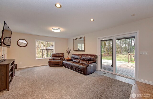 living room featuring recessed lighting and baseboards