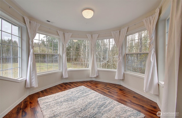 unfurnished sunroom featuring a wealth of natural light and visible vents