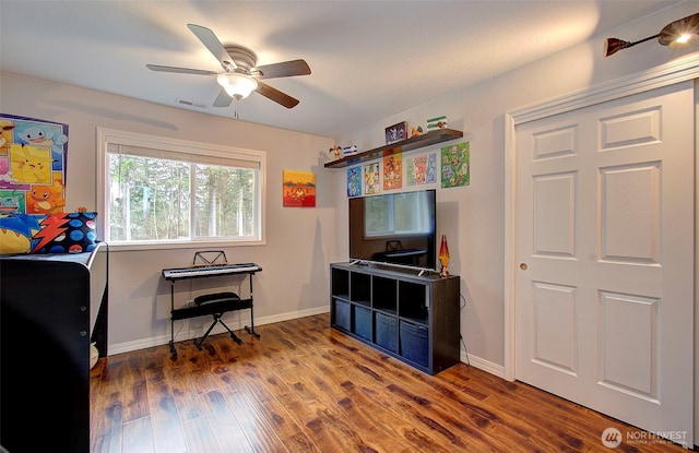 game room with visible vents, baseboards, wood finished floors, and a ceiling fan