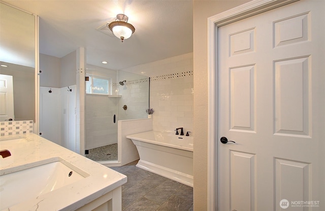 full bath featuring a bath, a stall shower, and vanity