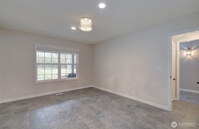 empty room featuring recessed lighting and baseboards