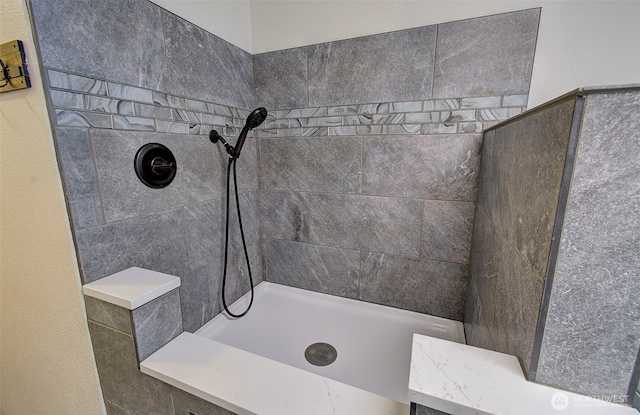 bathroom with a tile shower