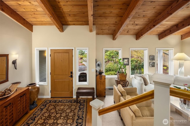 entryway with beam ceiling, wooden ceiling, and baseboards