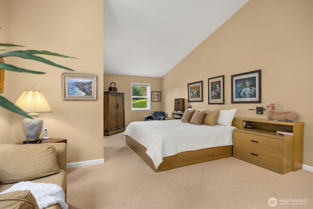 carpeted bedroom with baseboards and high vaulted ceiling