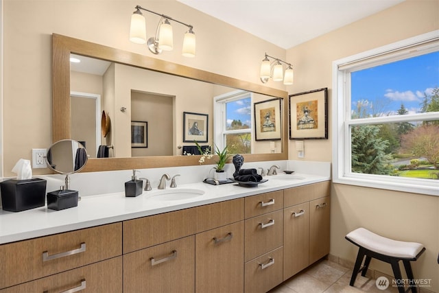 bathroom with a sink, double vanity, and tile patterned floors