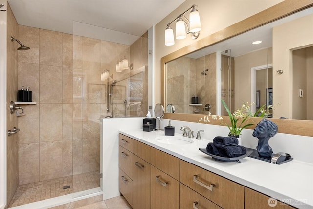 full bathroom with vanity, a stall shower, and tile patterned flooring