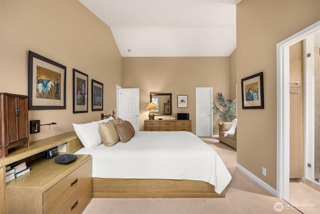 bedroom with baseboards, light colored carpet, and vaulted ceiling