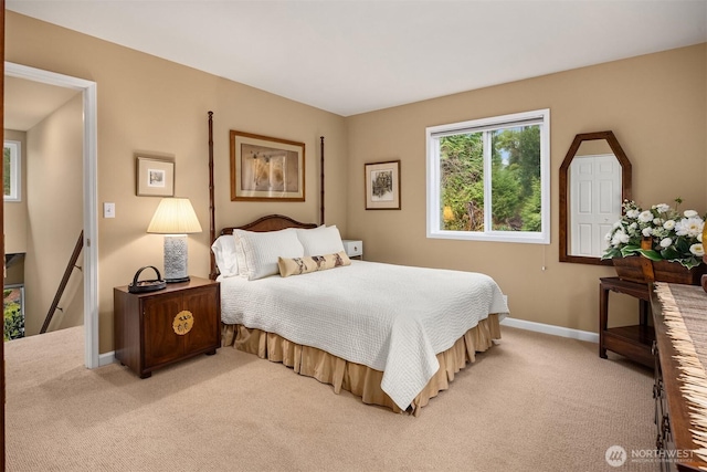 bedroom featuring light colored carpet and baseboards