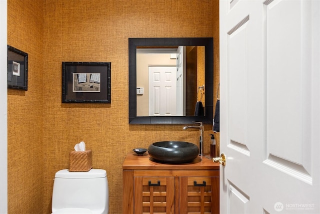 bathroom featuring vanity and toilet