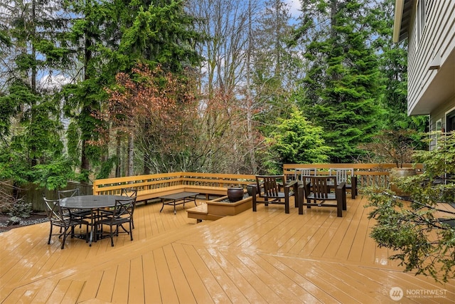 wooden terrace featuring outdoor dining space