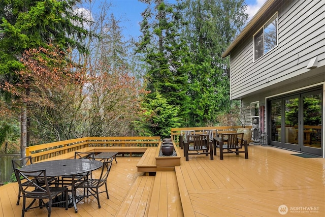 deck with outdoor dining space and french doors