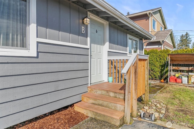 doorway to property featuring board and batten siding