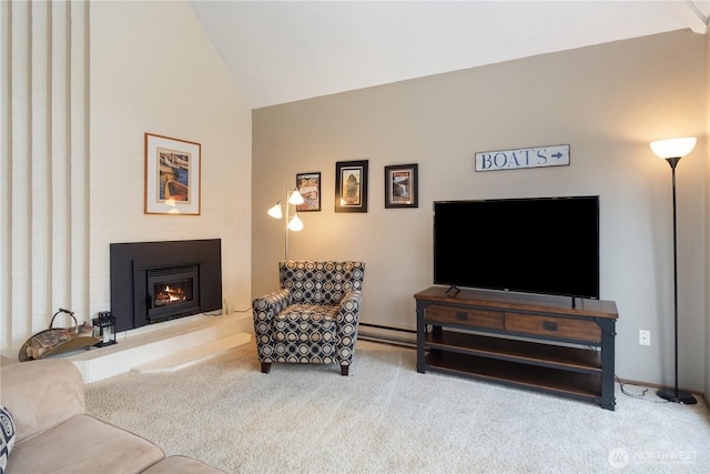 carpeted living room featuring lofted ceiling, a lit fireplace, and a baseboard radiator