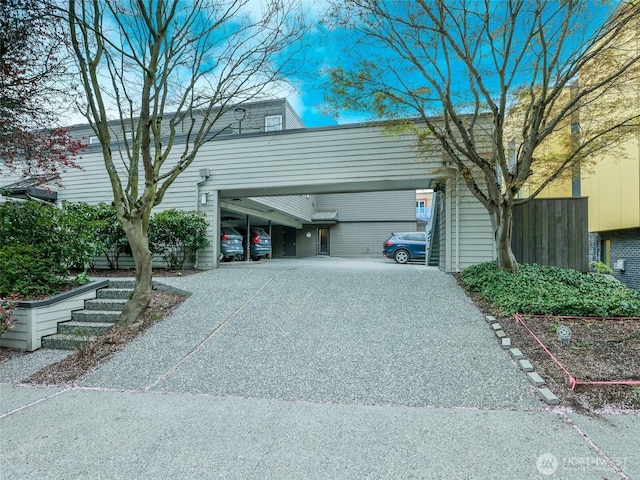 view of side of home featuring gravel driveway