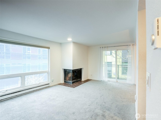 unfurnished living room featuring a baseboard radiator, carpet, baseboards, and a multi sided fireplace