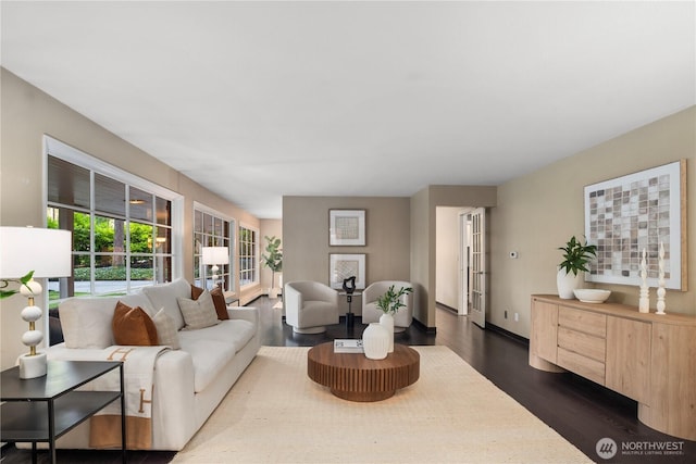 living room featuring dark wood-style floors and baseboards