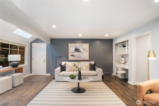 living room with dark wood-style floors, vaulted ceiling with skylight, recessed lighting, and baseboards