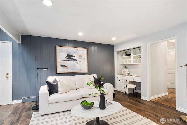 living room with a baseboard radiator, baseboards, dark wood-type flooring, and recessed lighting