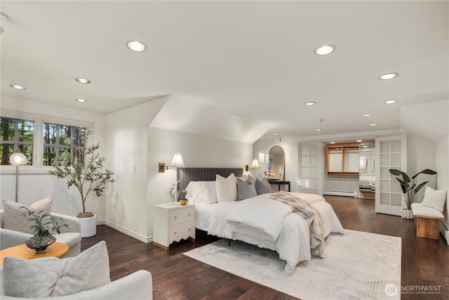 bedroom featuring arched walkways, lofted ceiling, recessed lighting, baseboard heating, and hardwood / wood-style flooring