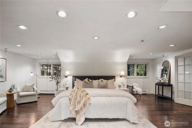 bedroom featuring a baseboard heating unit, recessed lighting, baseboards, and wood finished floors