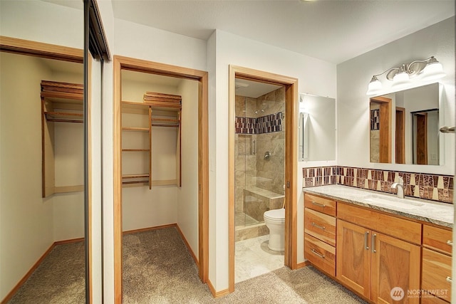 full bathroom with backsplash, toilet, a shower stall, vanity, and baseboards