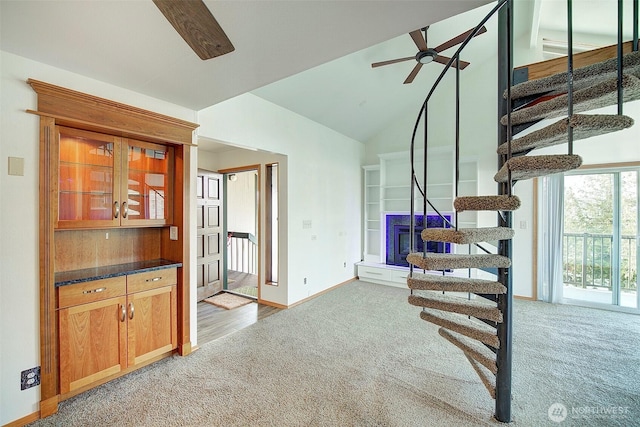 stairway featuring high vaulted ceiling, carpet, ceiling fan, and baseboards