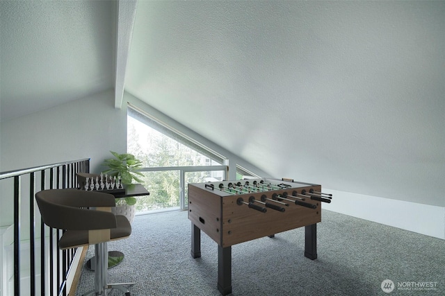 recreation room with lofted ceiling with beams, a textured ceiling, and carpet flooring