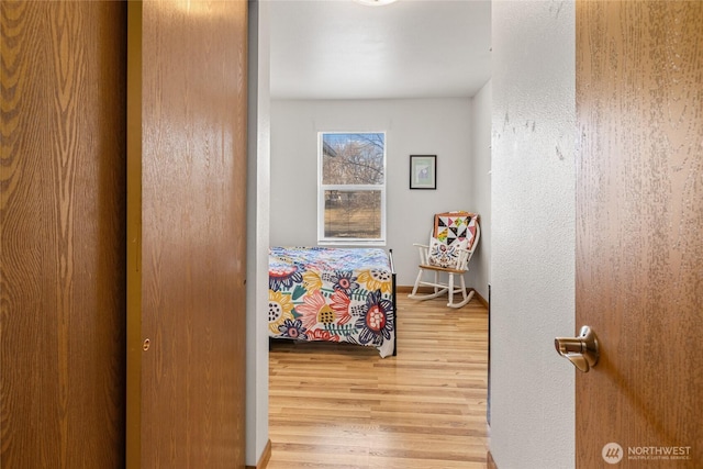 bedroom featuring baseboards and wood finished floors