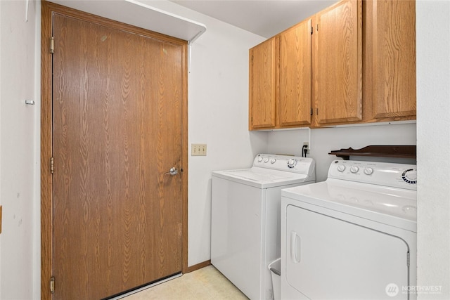 clothes washing area with cabinet space and washer and dryer