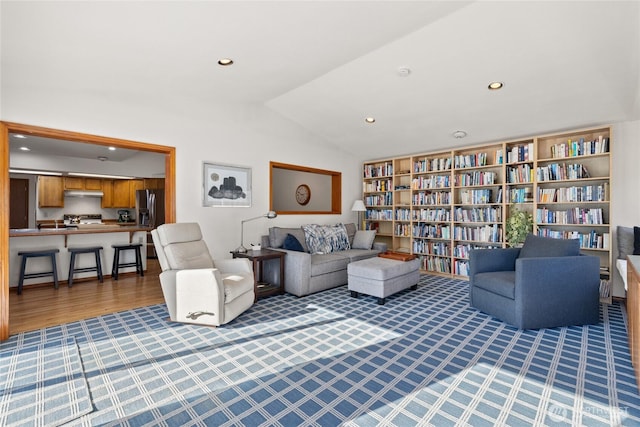 living room featuring vaulted ceiling, carpet, and recessed lighting