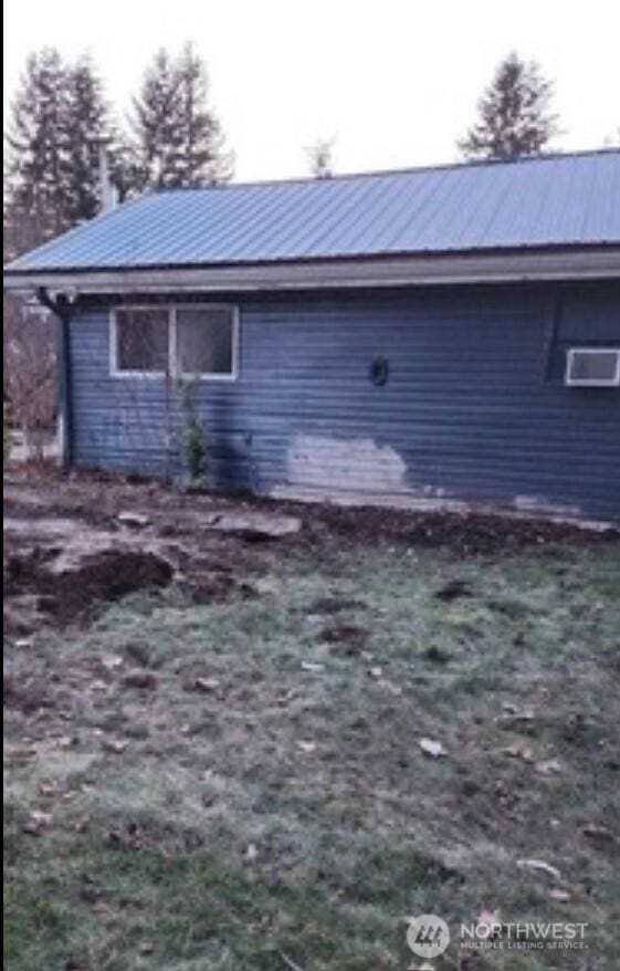 view of property exterior featuring metal roof