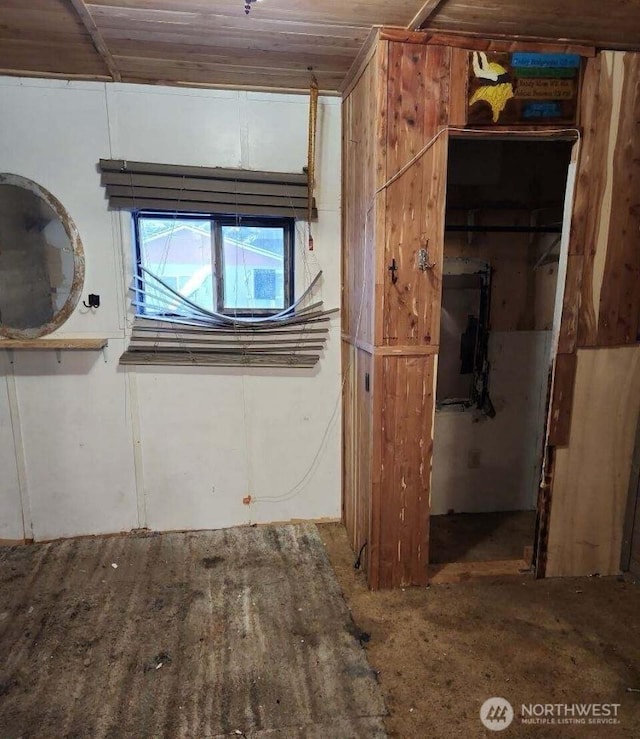 unfurnished bedroom featuring a walk in closet and a closet