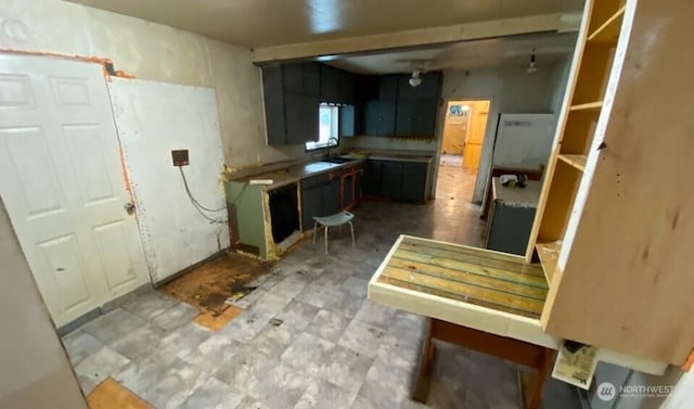 kitchen featuring light floors and a sink