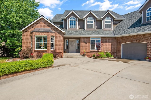 view of front of house featuring driveway, brick siding, an attached garage, and a shingled roof