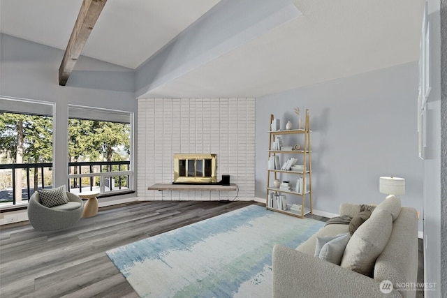 living room featuring a brick fireplace, beamed ceiling, baseboards, and wood finished floors