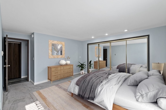 bedroom featuring recessed lighting, a closet, light carpet, and baseboards