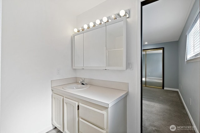 bathroom with vanity and baseboards