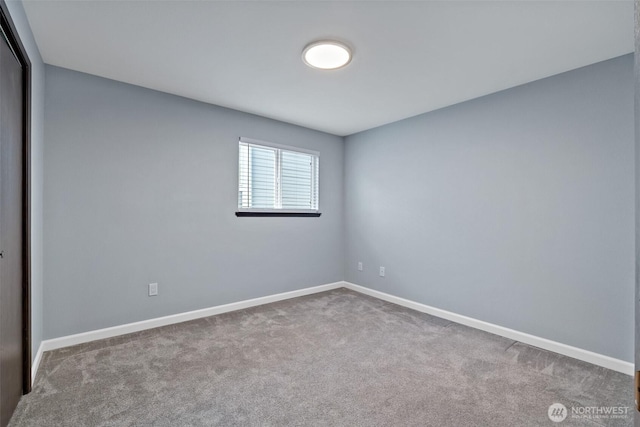 spare room with carpet and baseboards