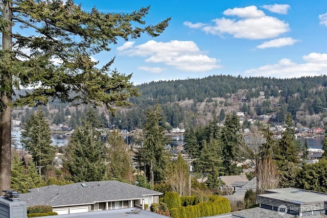 drone / aerial view featuring a forest view